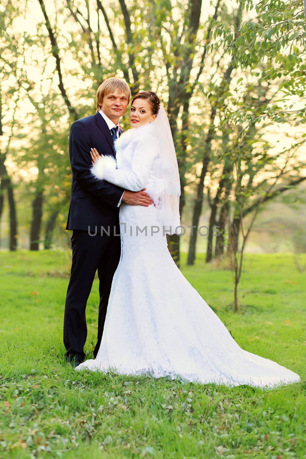 Photo of happy newlyweds. Beautiful young bride and groom in love.