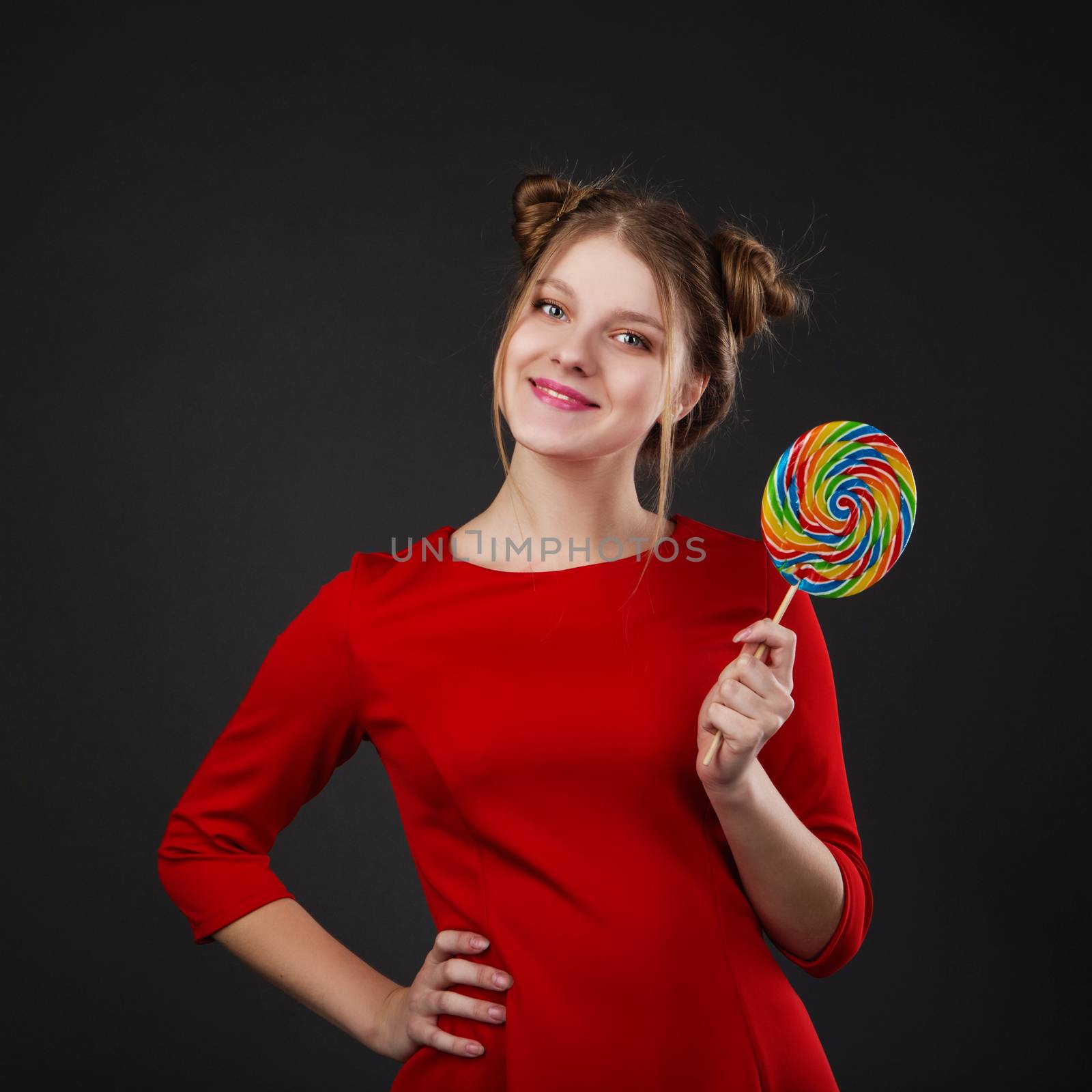 Portrait of a smiling young beautiful girl in a red dress with a by natazhekova