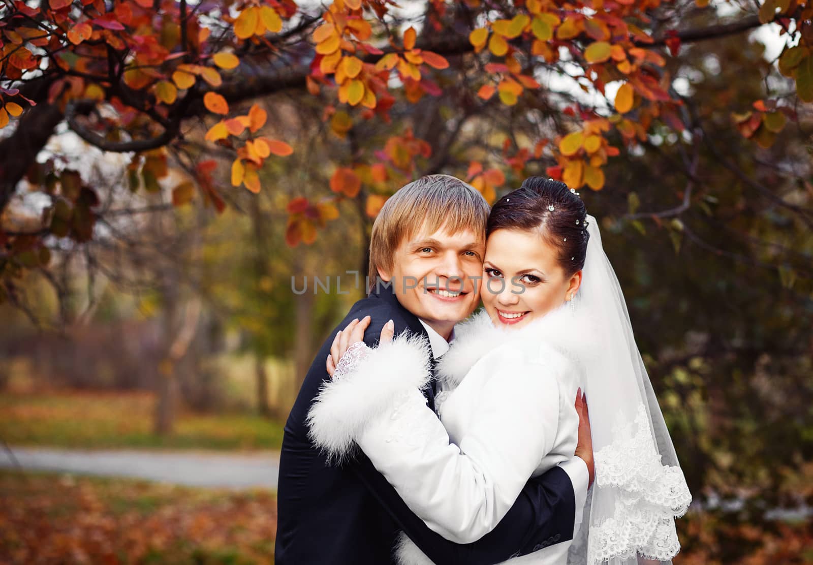 Photo of happy newlyweds outdoors. by natazhekova