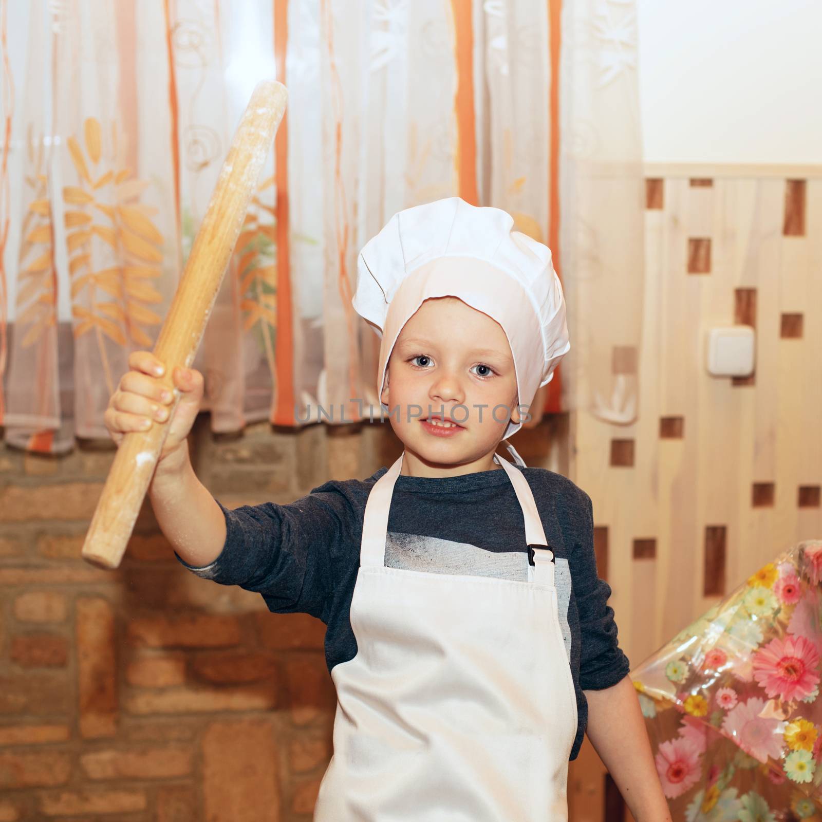 Children make pizza. Master class for children on cooking Italian pizza. Young children learn to cook a pizza. Kids preparing homemade pizza. Little cook.