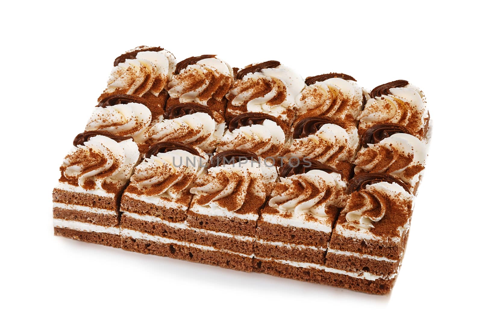 Chocolate biscuit cake decorated with cream flowers isolated on white background