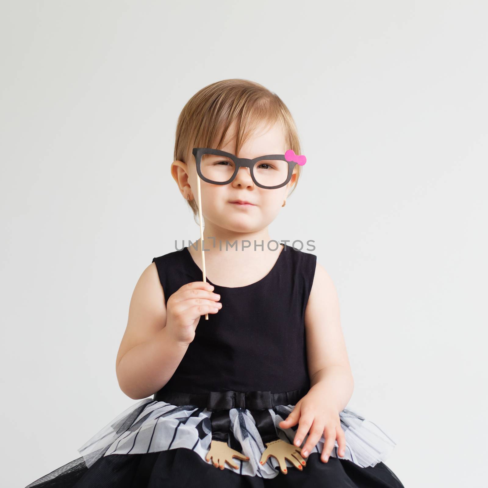 Portrait of a lovely little girl with funny photo props paper gl by natazhekova