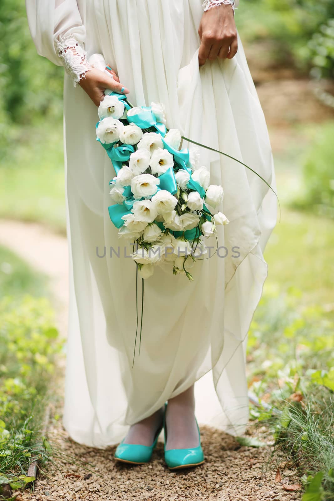 Beautiful wedding bouquet in hands of the bride