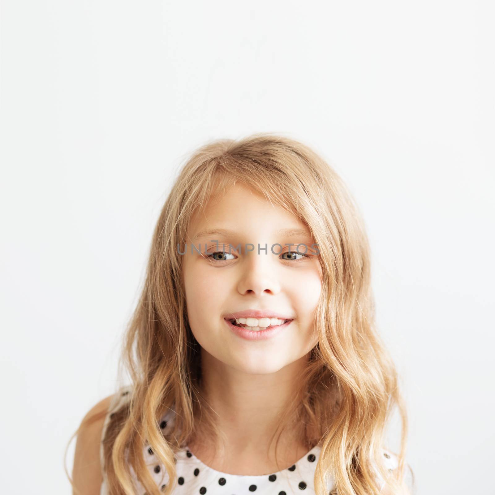 Closeup portrait of a lovely little girl against a white background