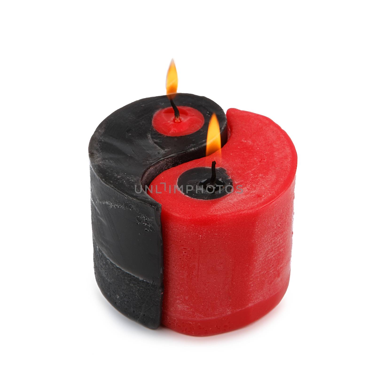 Red and black Yin Yang handmade candle isolated on white background. Double candle. Two candles in one