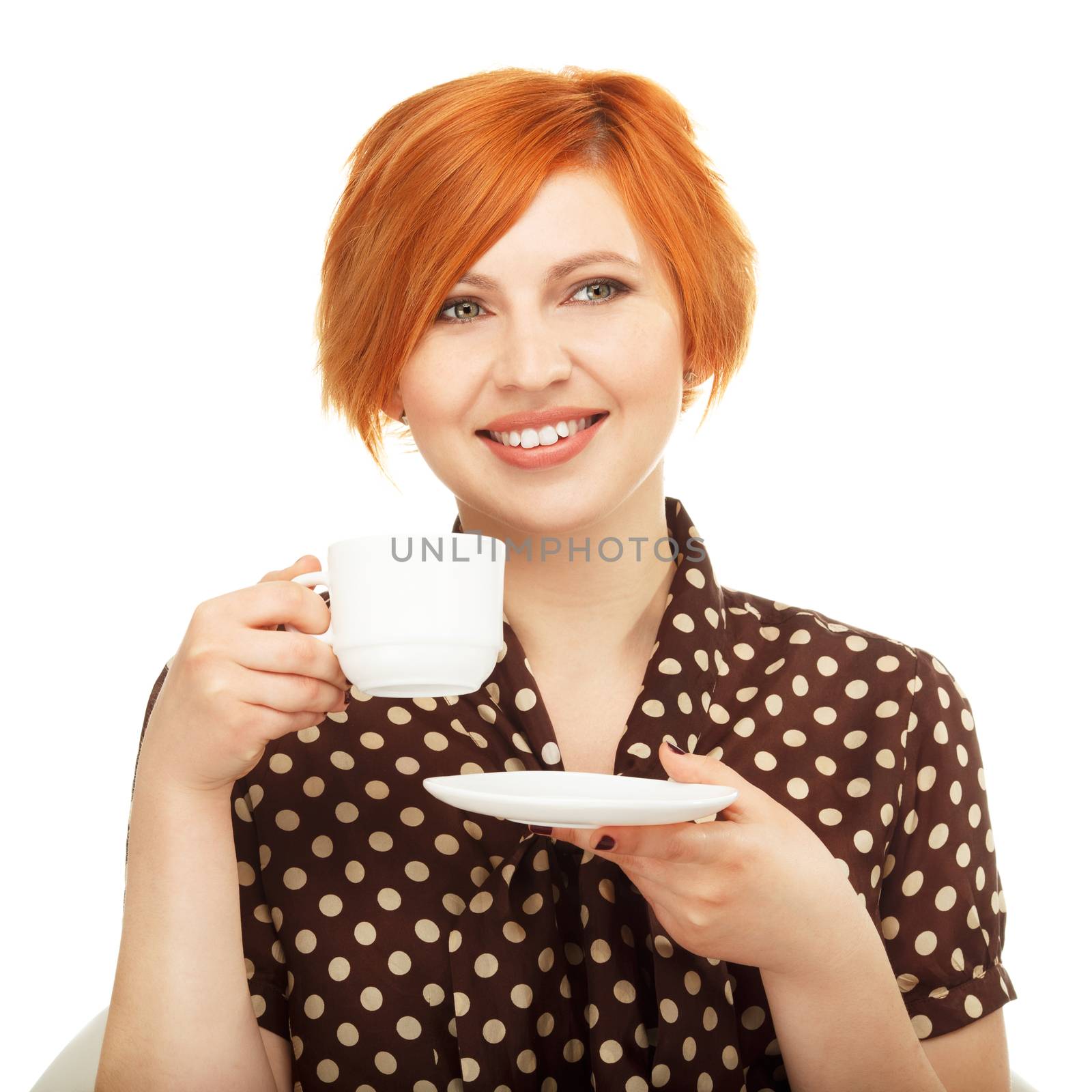 smiling young woman drinking from a cup isolated on white background