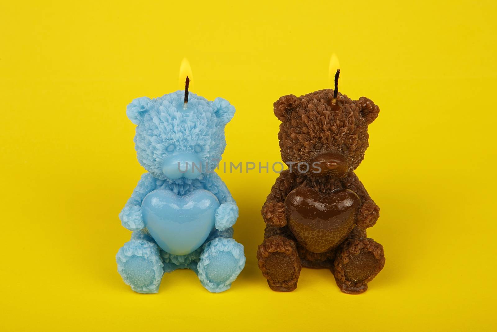 Colorful handmade candles in the shape of teddy-bear. Funny child candles. Souvenir gift candles. Light the candles. A burning candle. Candle lit. Candle Light