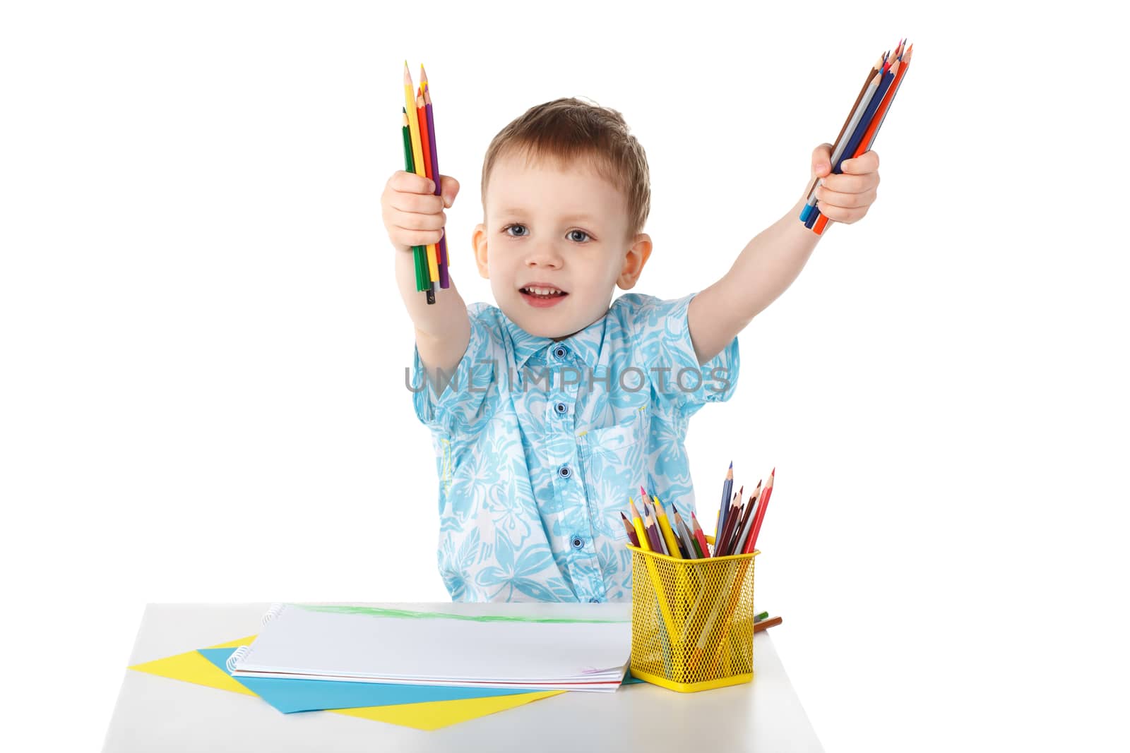 Little boy holding a lot of colored pencils isolated on white background