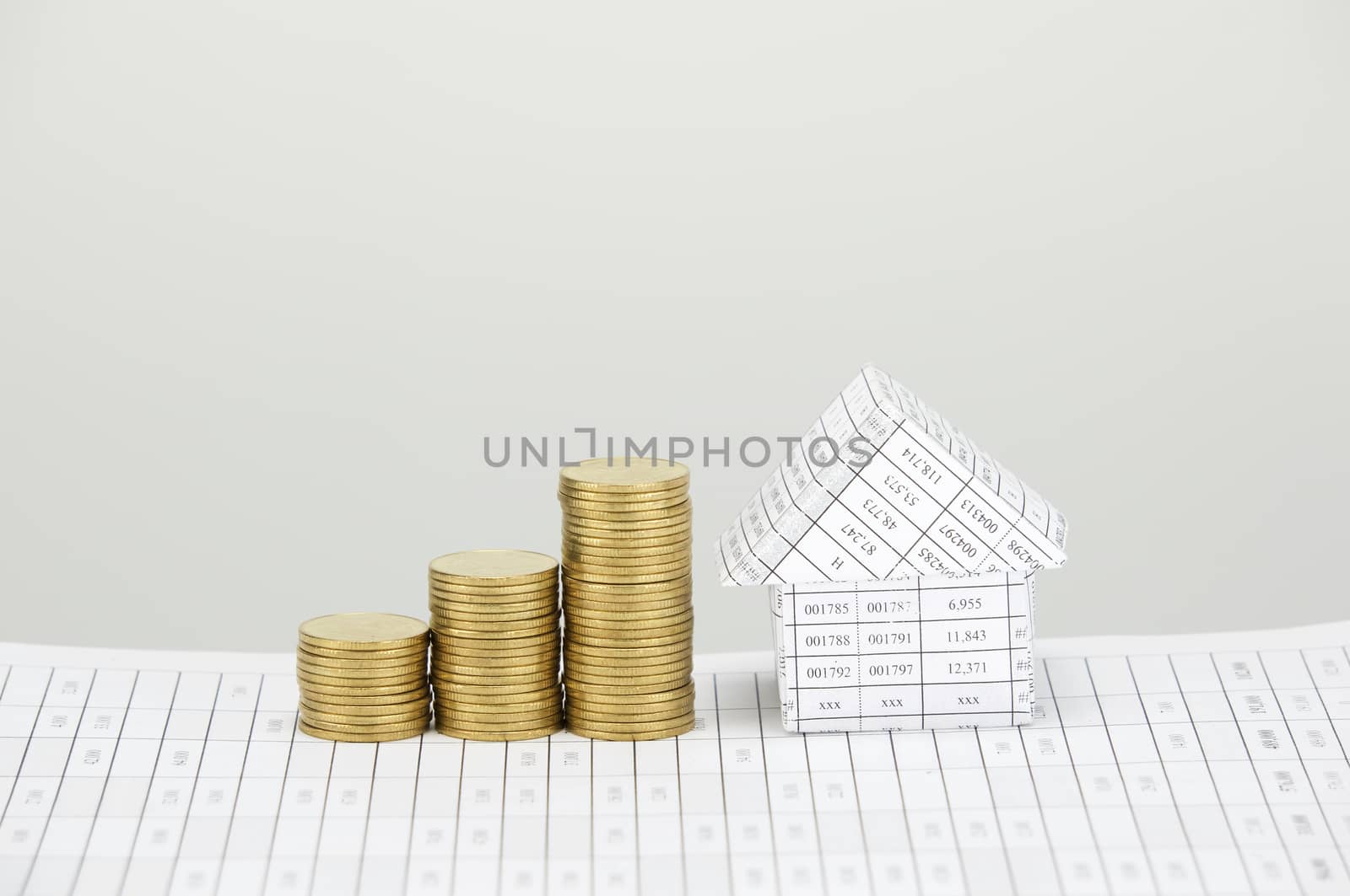 House and step pile of gold coins on finance account with white background.