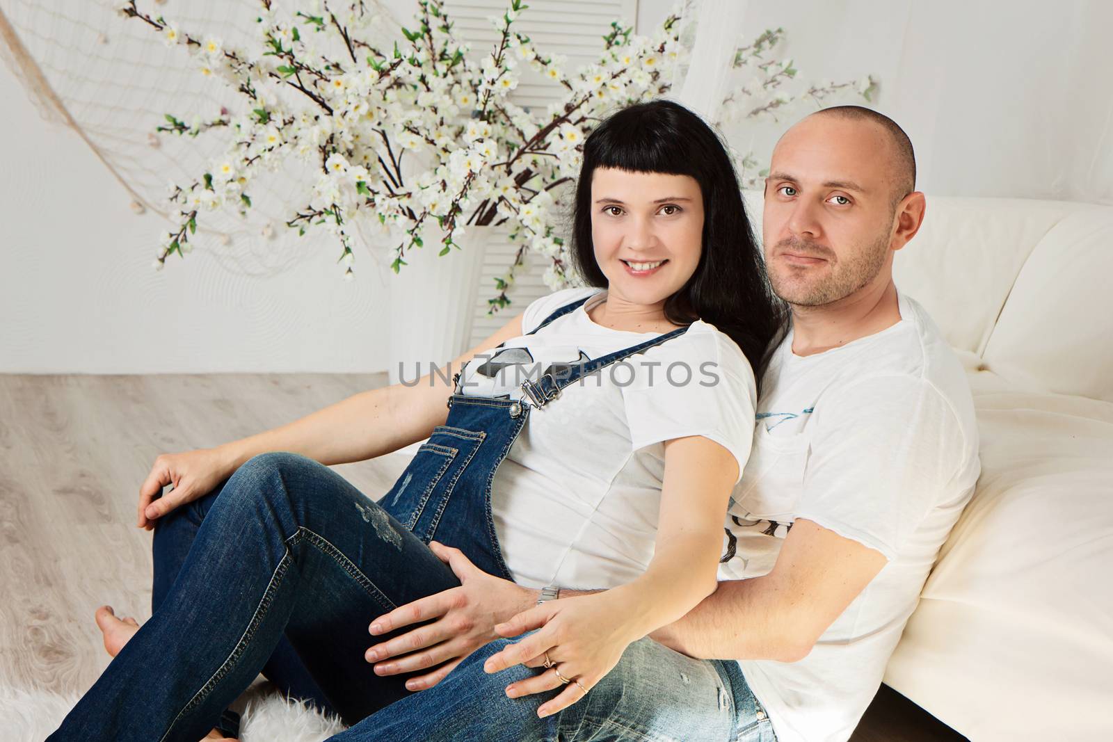 Pregnant woman with her loving husband in a happy anticipation of the baby