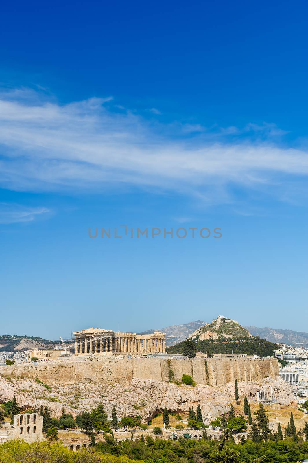 Ancient Acropolis in rays of sunset. Athens Greece. Copyspace.