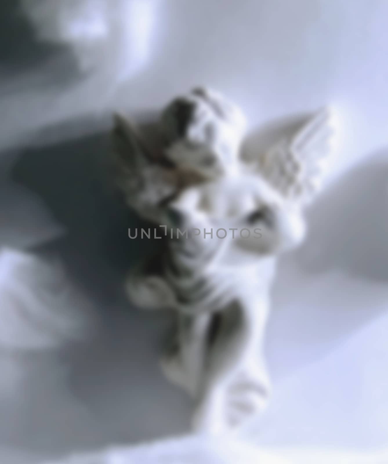 white angel figurine blurred by KoliadzynskaIryna
