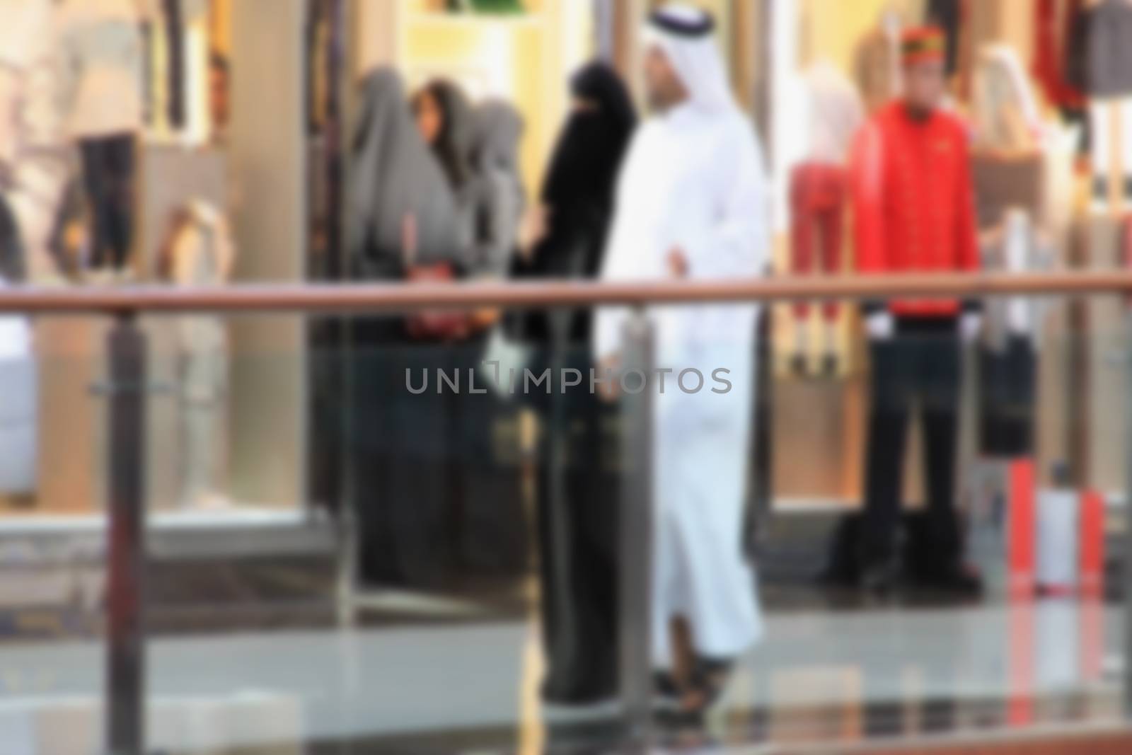 Arab sheikhs men and their wives and families in a mall make a p by KoliadzynskaIryna