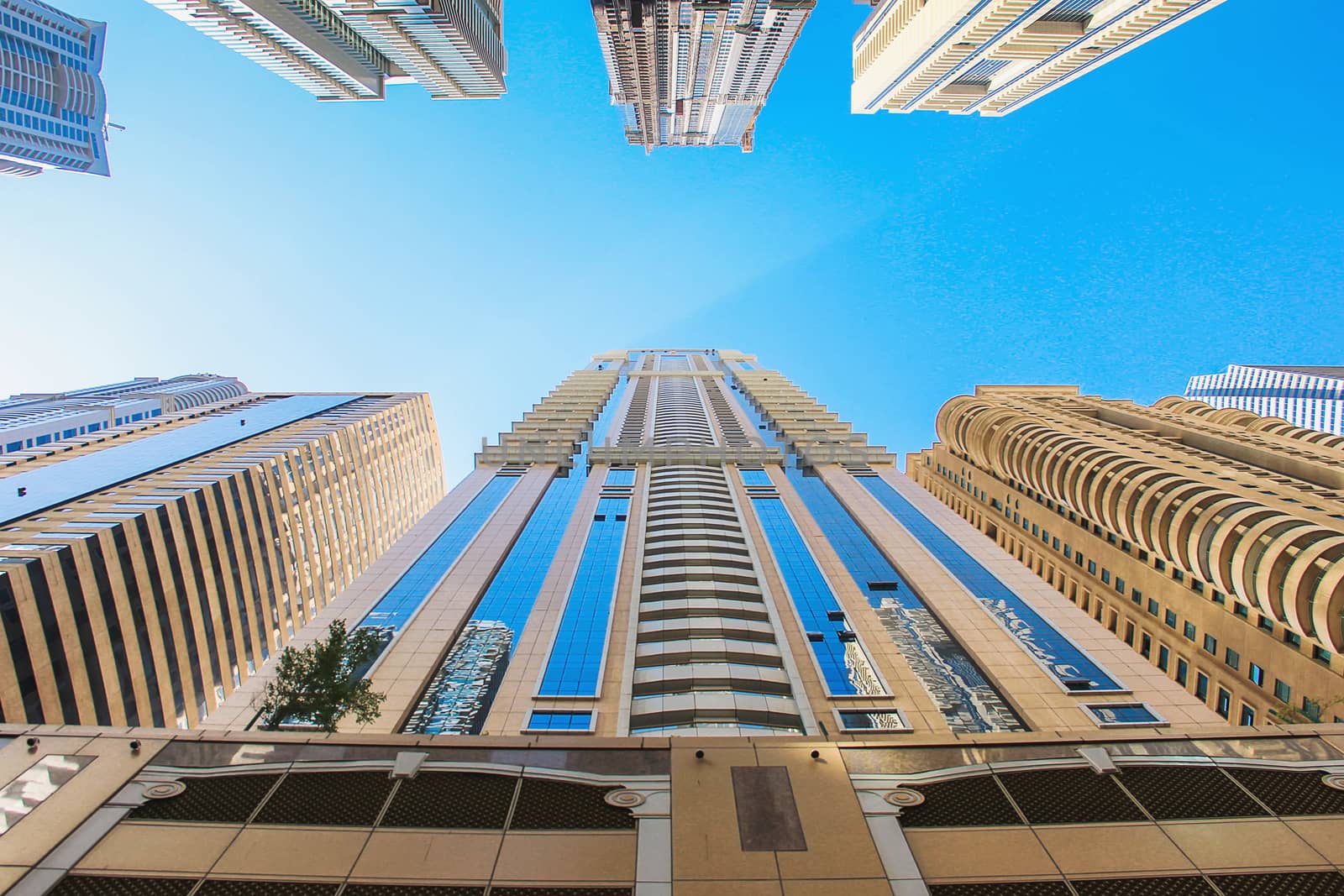 United Arab Emirates Dubai April 7, 2014, skyscrapers high rise buildings view from below against the blue sky modern architecture soft focus