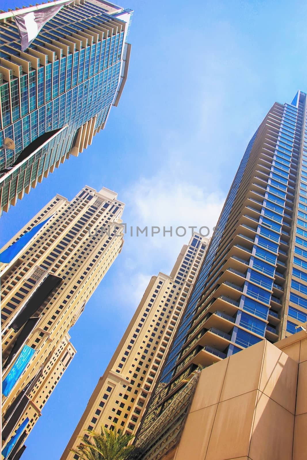 United Arab Emirates Dubai April 7, 2014, skyscrapers high rise buildings view from below against the blue sky modern architecture soft focus
