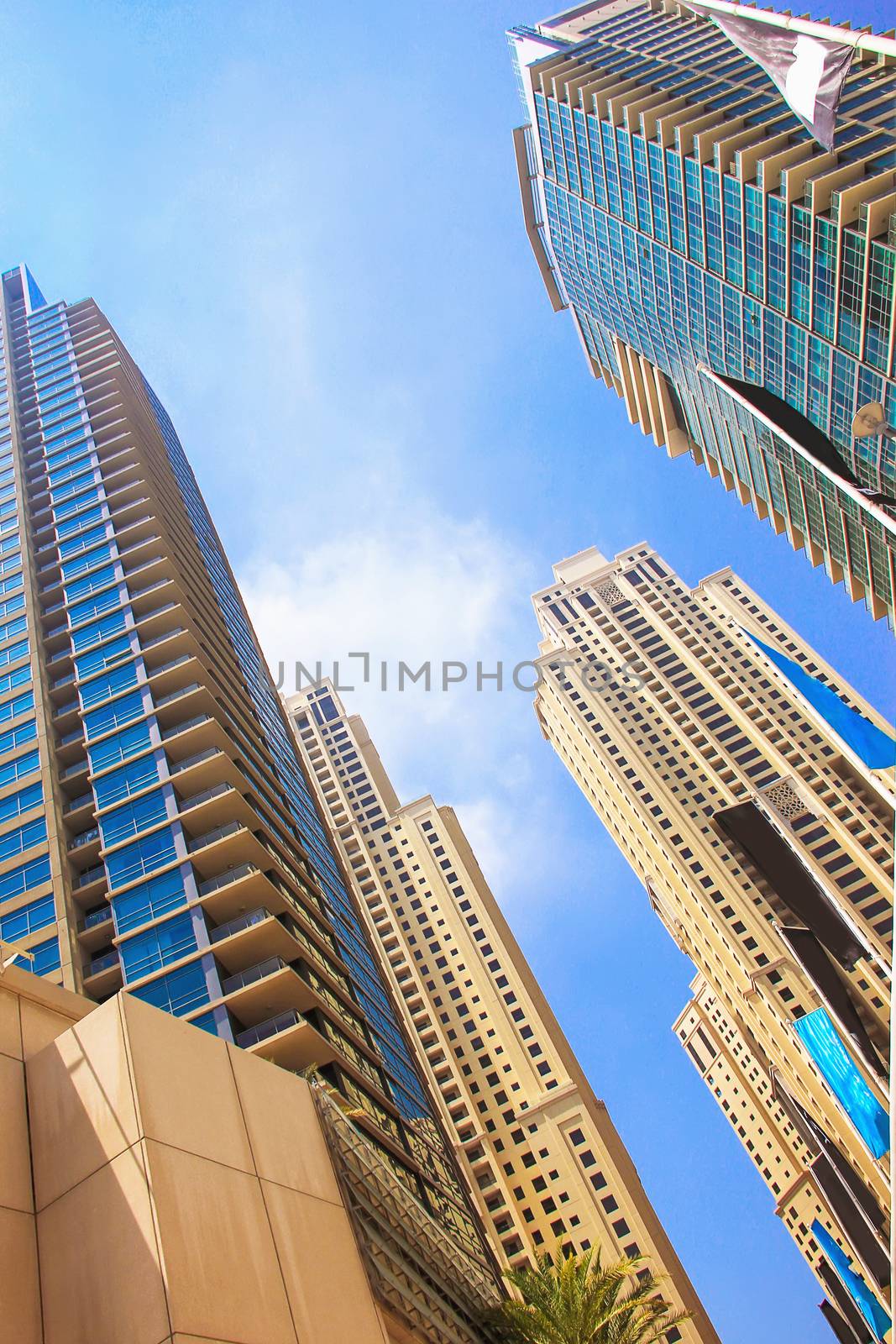 skyscrapers and high-rise buildings and houses .Emiraty, April 7, 2014 in Dubai, view from below against the blue sky modern architecture, new technology building soft focus