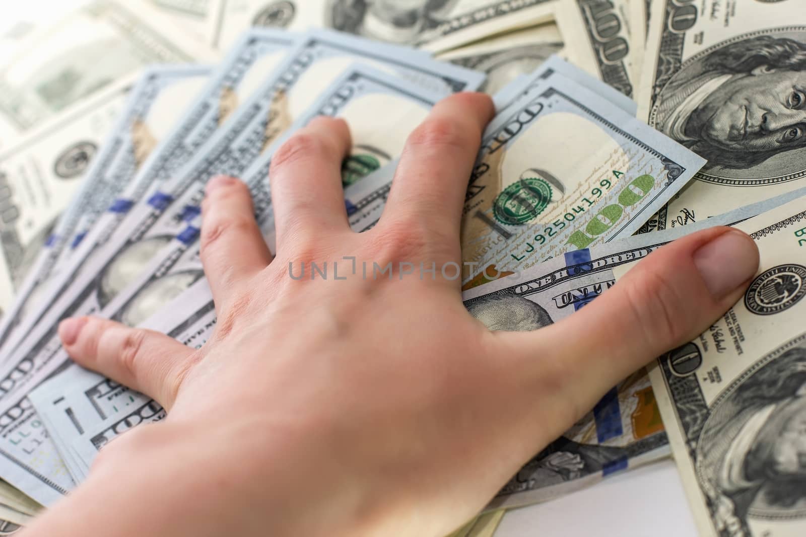 hand holds the hundred-dollar bills Hand with money, 100 dollar bills, receive money in the bank