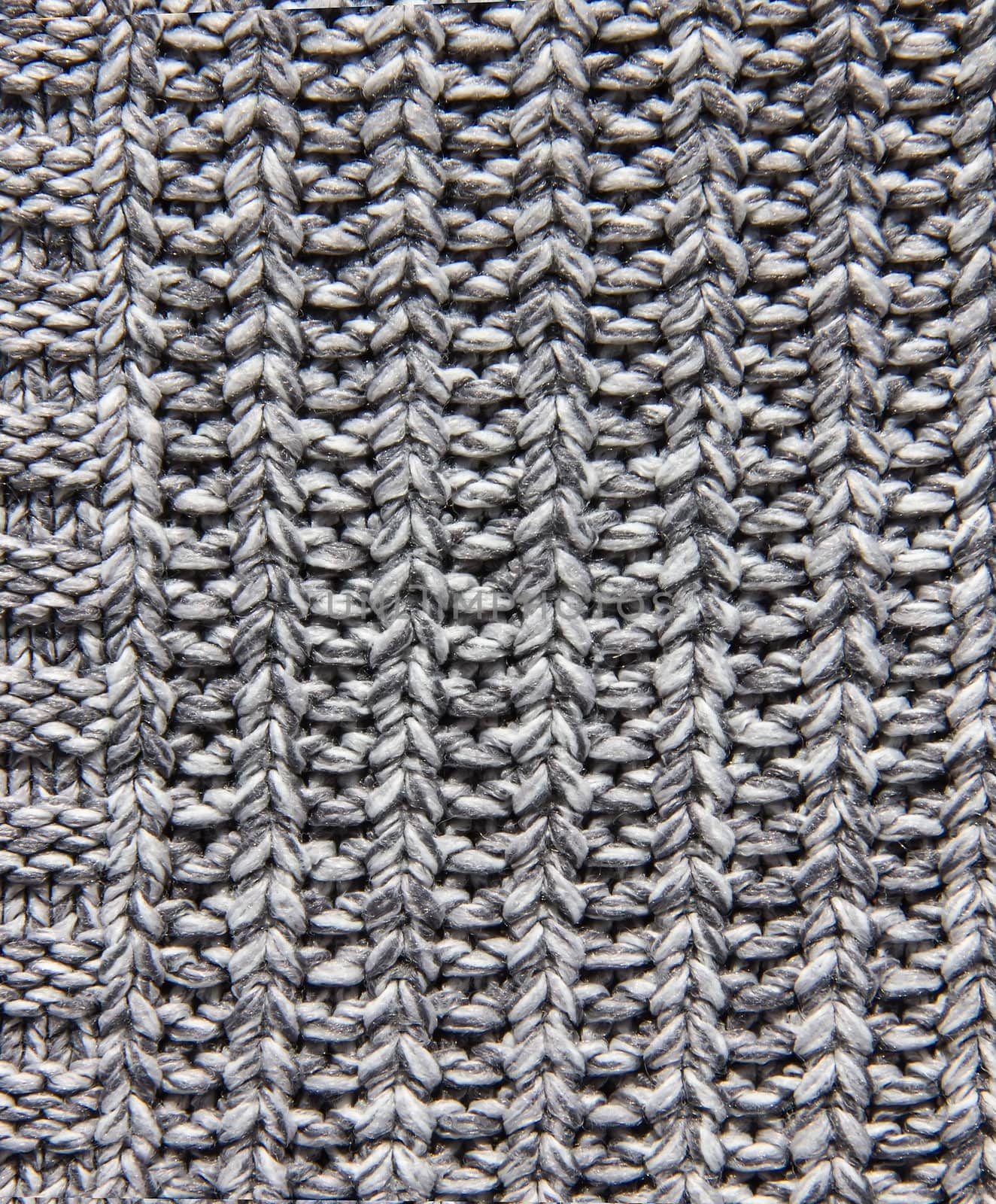 texture of knitted fabric, knitted gray background, Melange wool knitwear as a background.