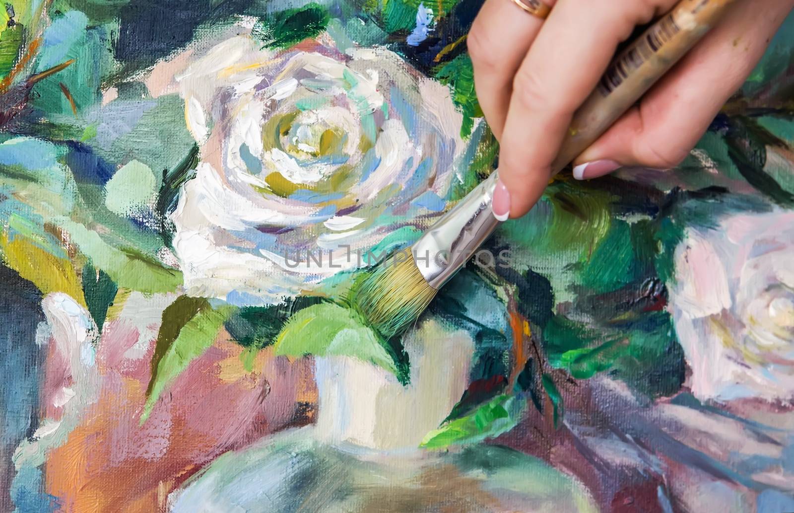 Brush and oil paints on a palette, paint a picture of the artist's hands, texture mix paint in different colors. Artist holding a palette with paint, brushes and palette knife