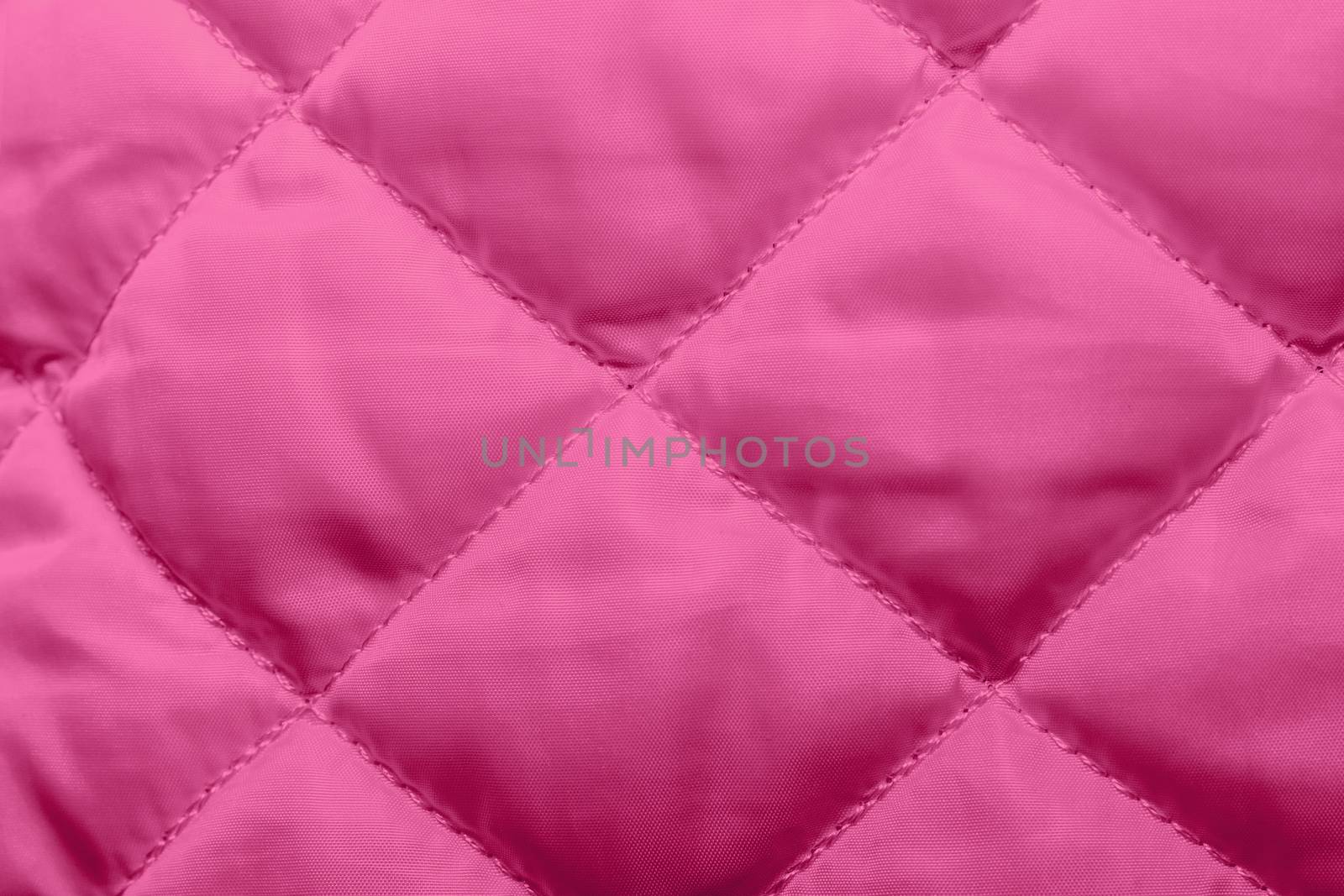 quilted fabric texture of pink color for hammering, backgrounds and textures