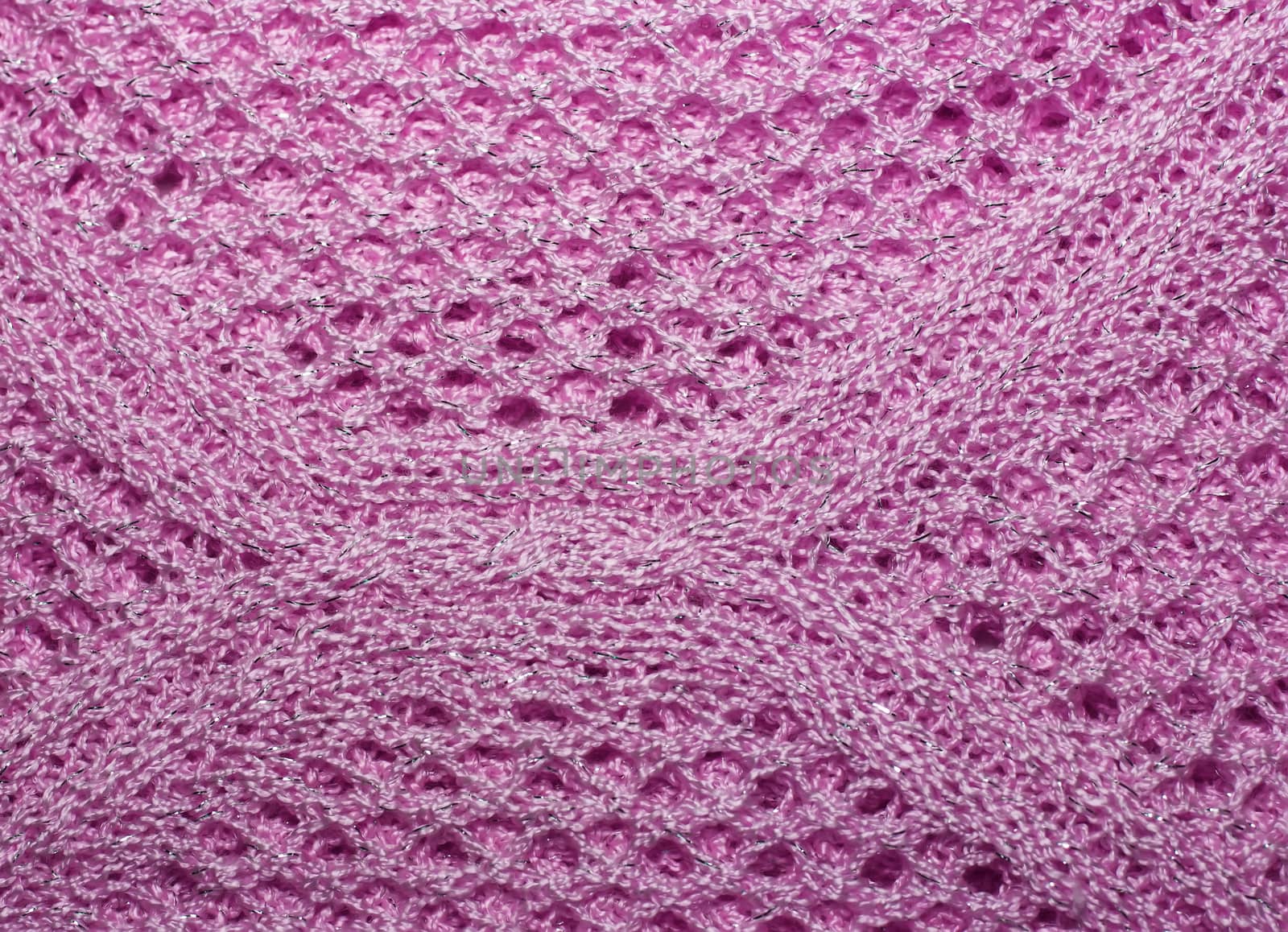 Pink knitted wool fabric texture closeup. with lurex thread, Jersey Knitted background with a relief pattern