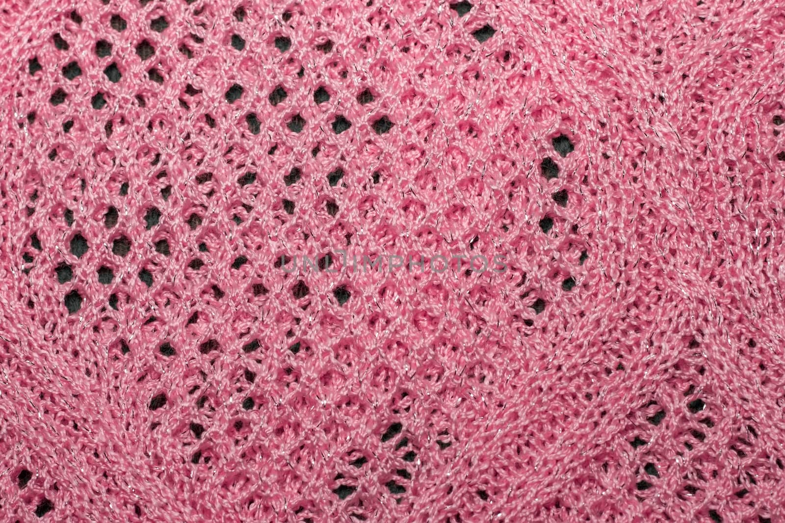 Pink knitted wool fabric texture closeup. with lurex thread, Jersey Knitted background with a relief pattern