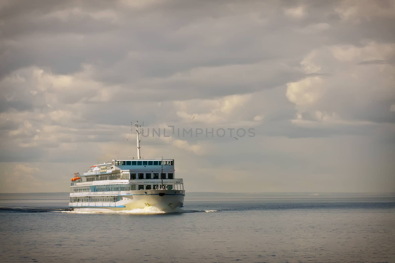 Cruise ship in open water front view