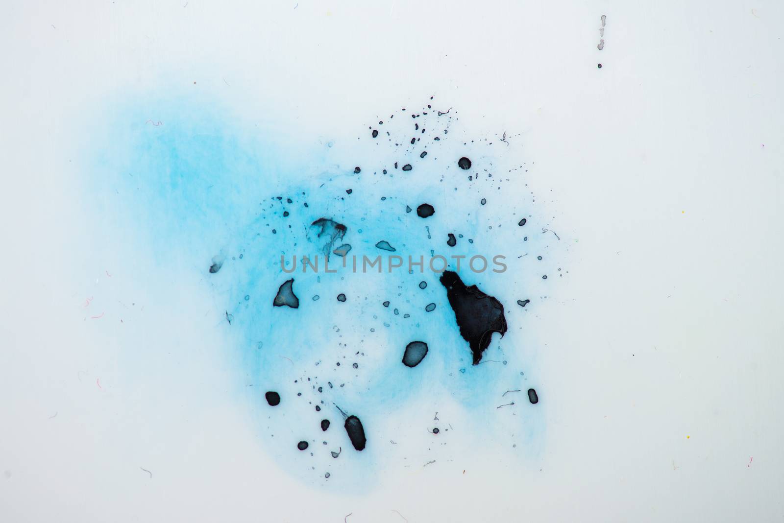 Blue paint splash isolated grunge texture on white plastic. photo.