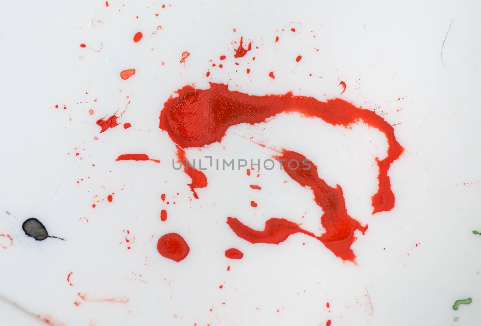 red paint splash isolated grunge texture on white plastic. photo by skrotov