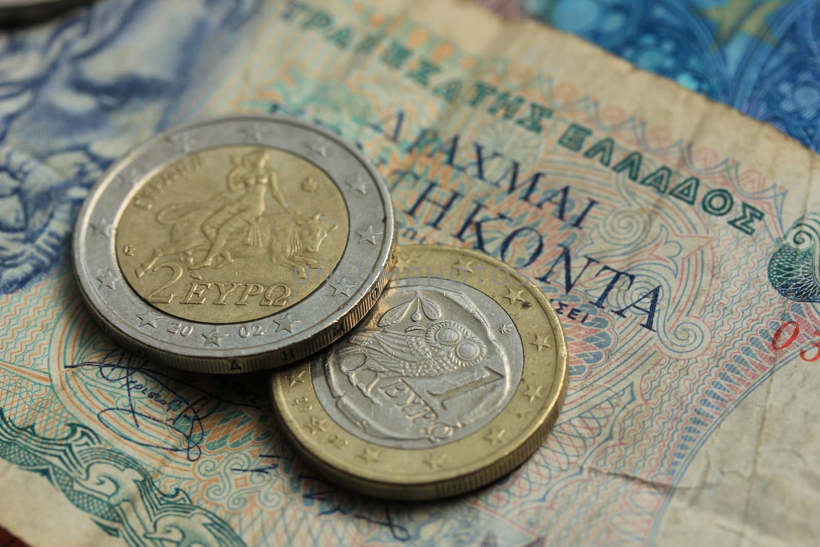 Euro coins from Greece on a vintage greek bank note