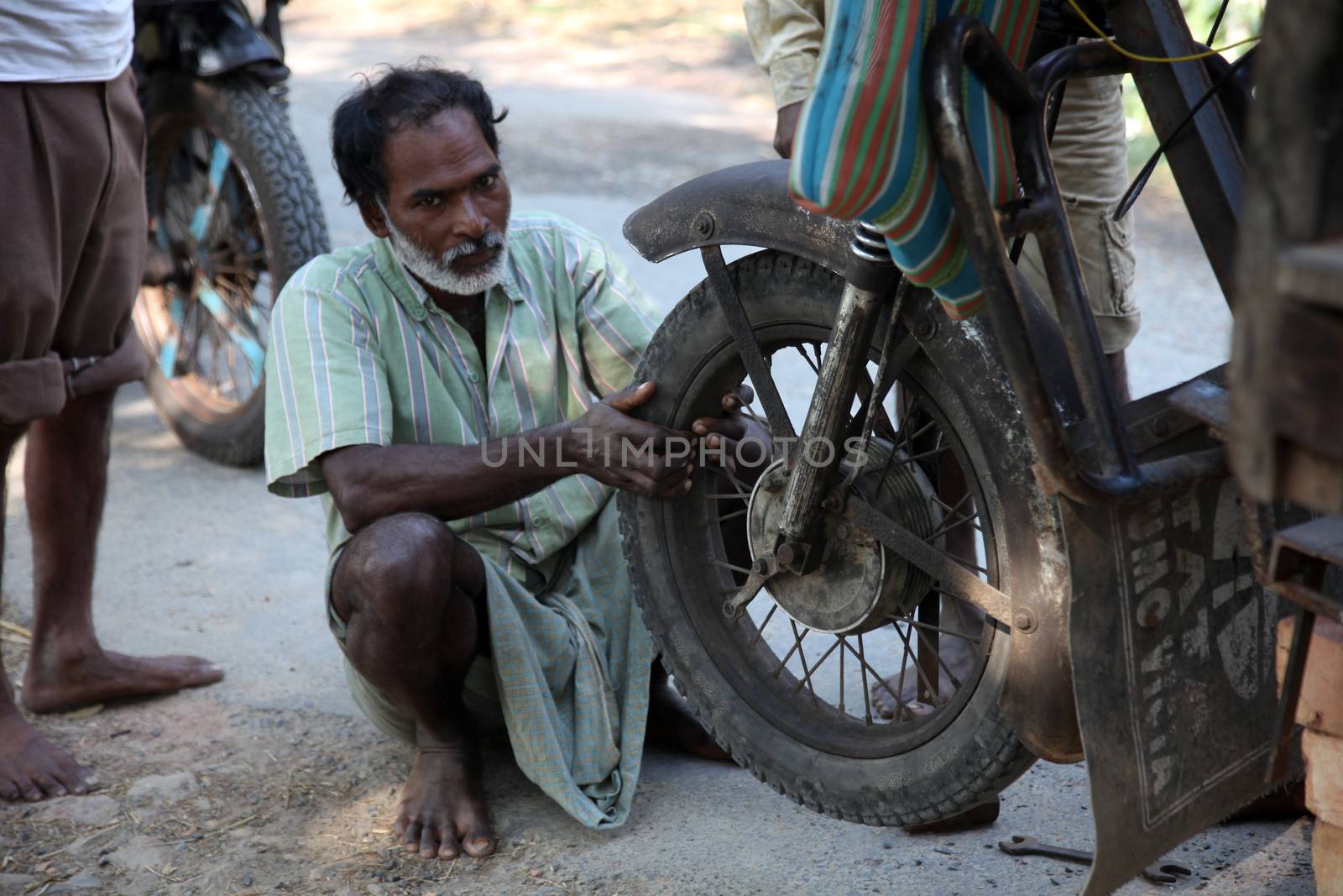 Mechanic repair the motorbike. Bikes is the common individual transport in India.