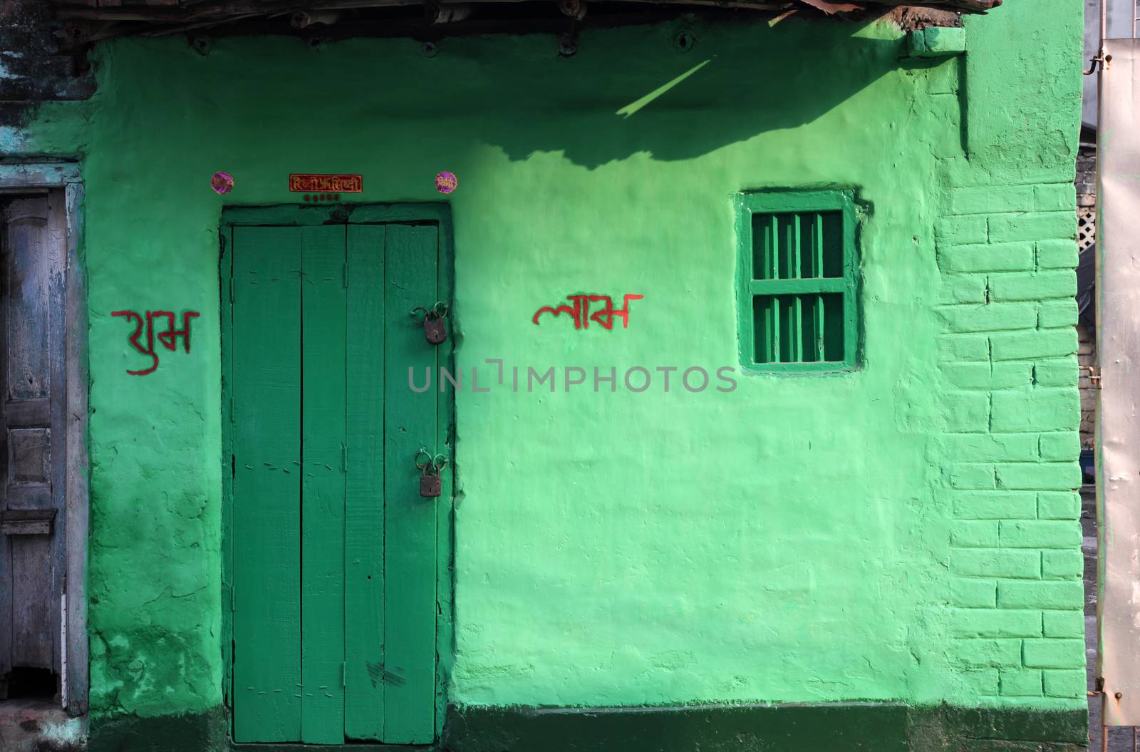 Colorful Indian house. Bright green building in Kolkata, West Bengal, India on February 23, 2012.