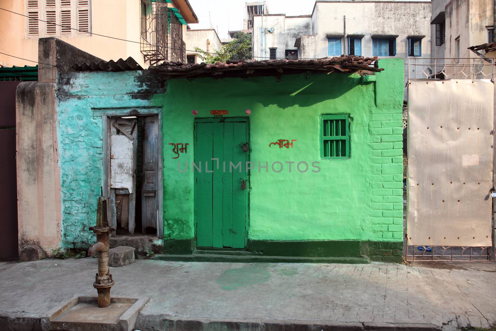 Colorful Indian house. Bright green building in Kolkata, West Bengal, India on February 23, 2012.