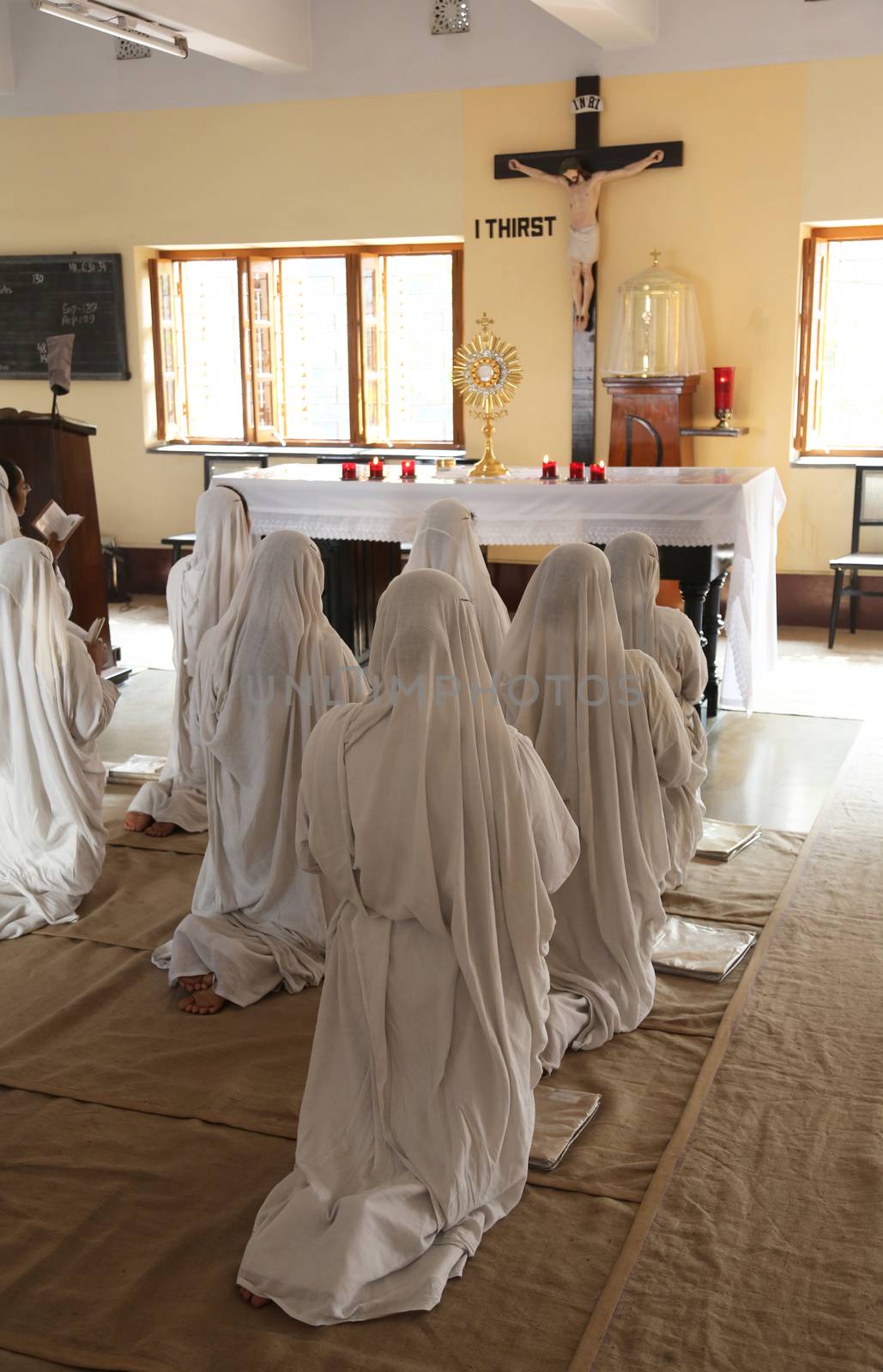 Sisters of Mother Teresa's Missionaries of Charity in prayer in the chapel of the Mother House, Kolkata by atlas