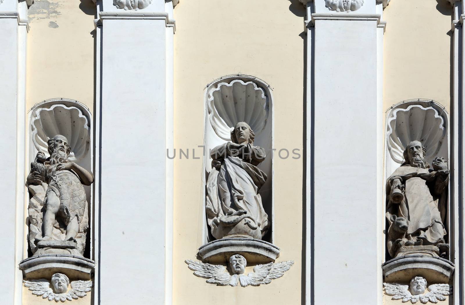 Saint Gregory the Great, Jesus Christ and Saint Jerome on the portal of Holy Cross, parish Church of the Immaculate Conception of the Virgin Mary in Lepoglava, Croatia