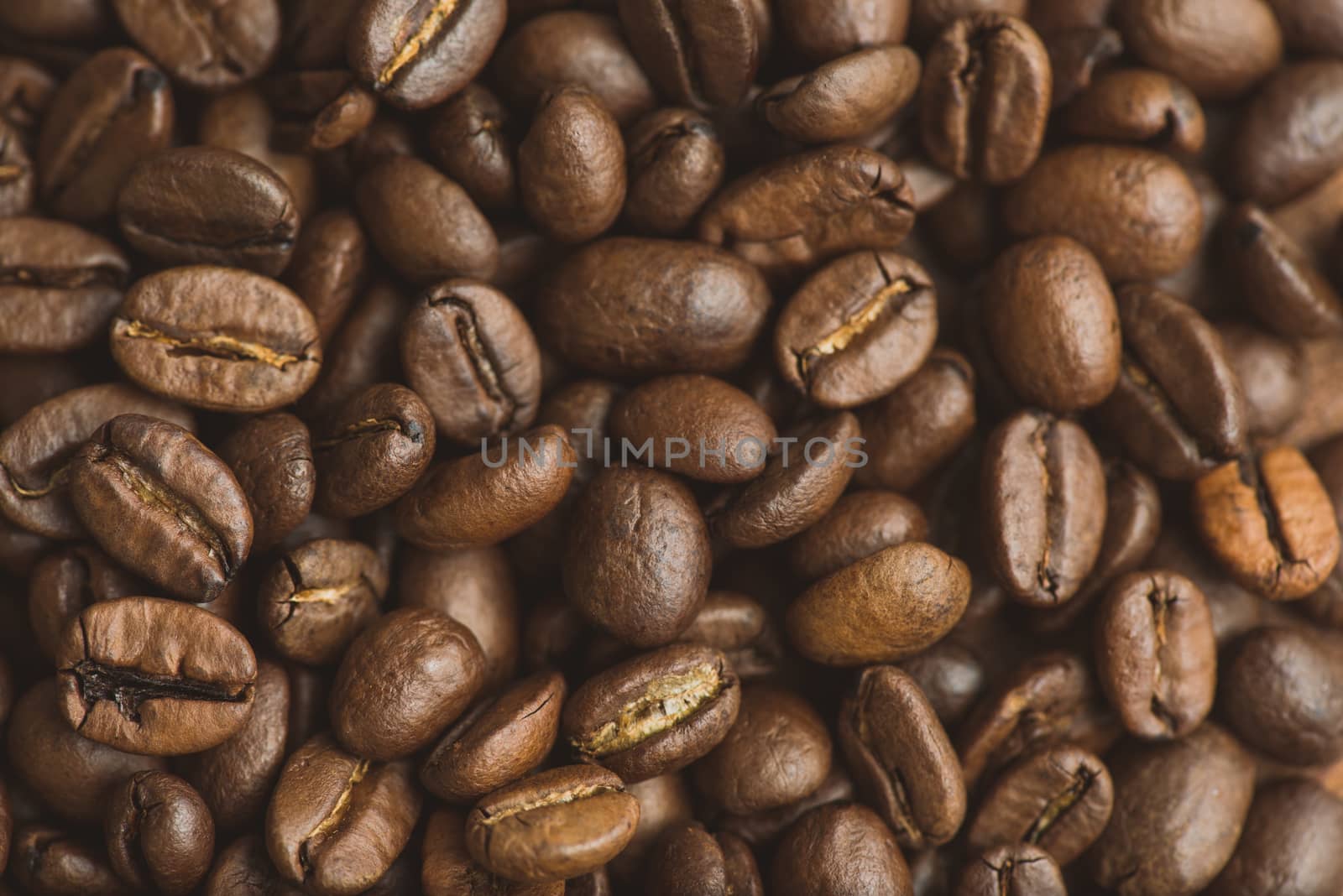 Brown coffee beans, closeup of macro coffee beans for background and texture by skrotov