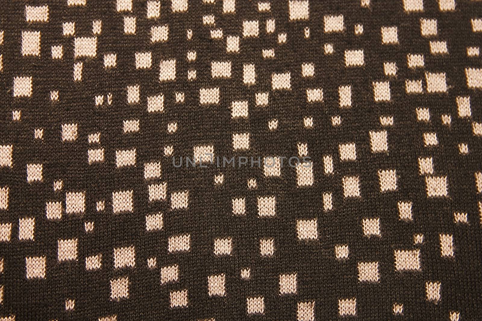 Ornament in black knitted wool knitted warm clothes for the winter fabric texture background