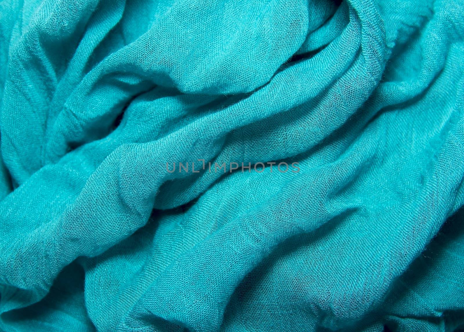 fabric texture cotton and silk crumpled blue folds lying on a ta by KoliadzynskaIryna