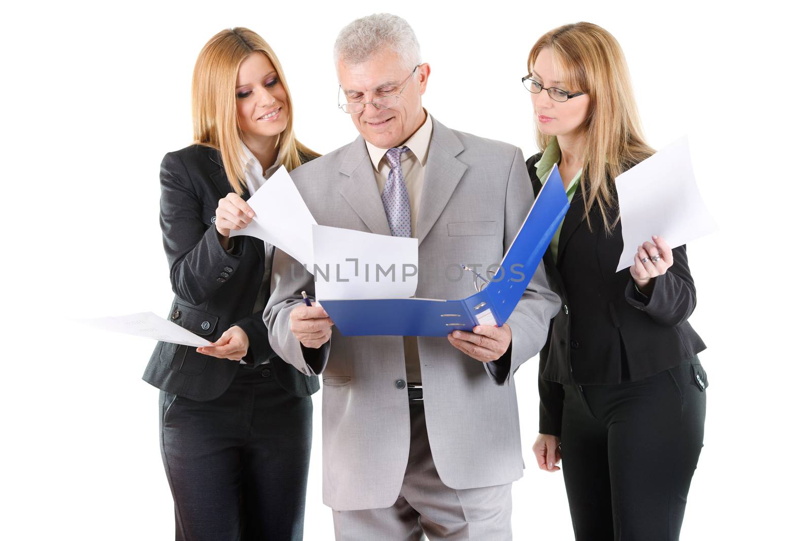 Three smiling business people looking at documents