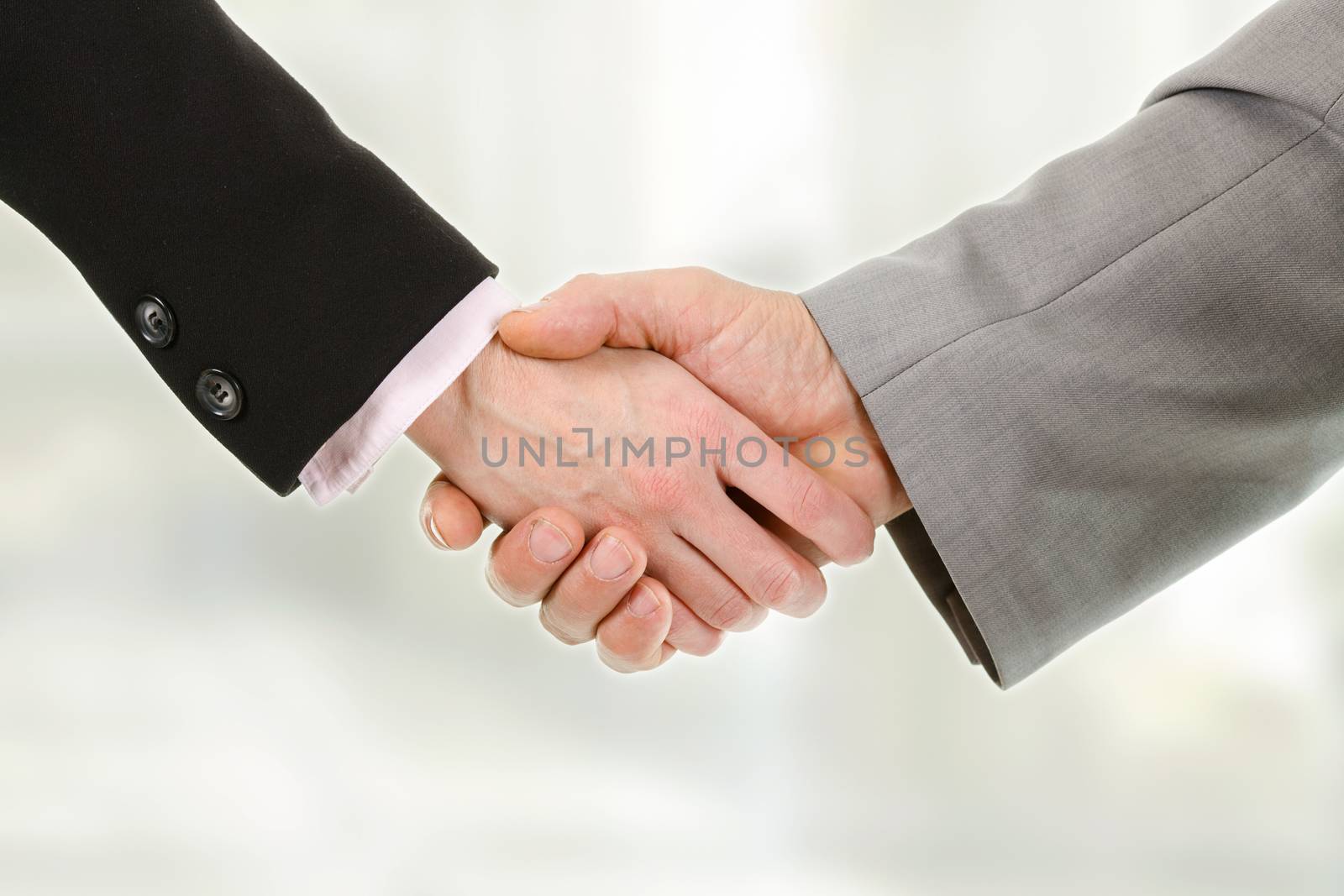 Closeup of business people shaking hands with each other by MilanMarkovic78