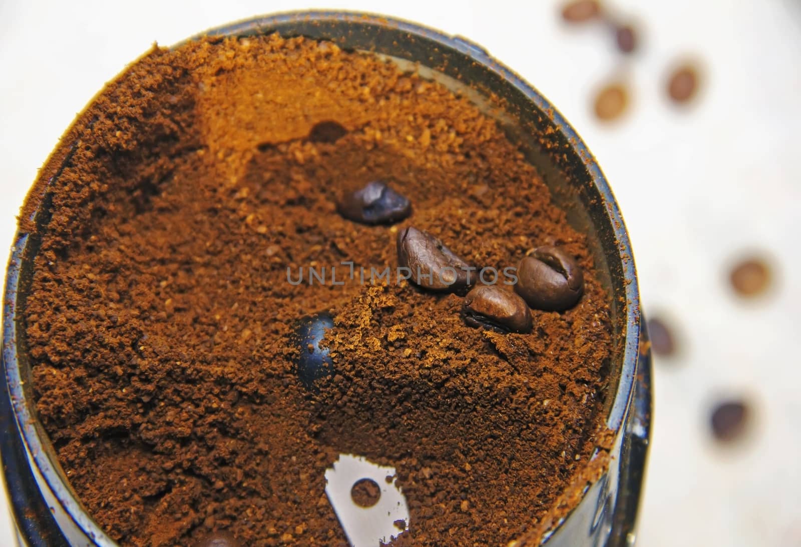coffee is ground in a coffee grinder Natural ground coffee heap and coffee beans soft focus