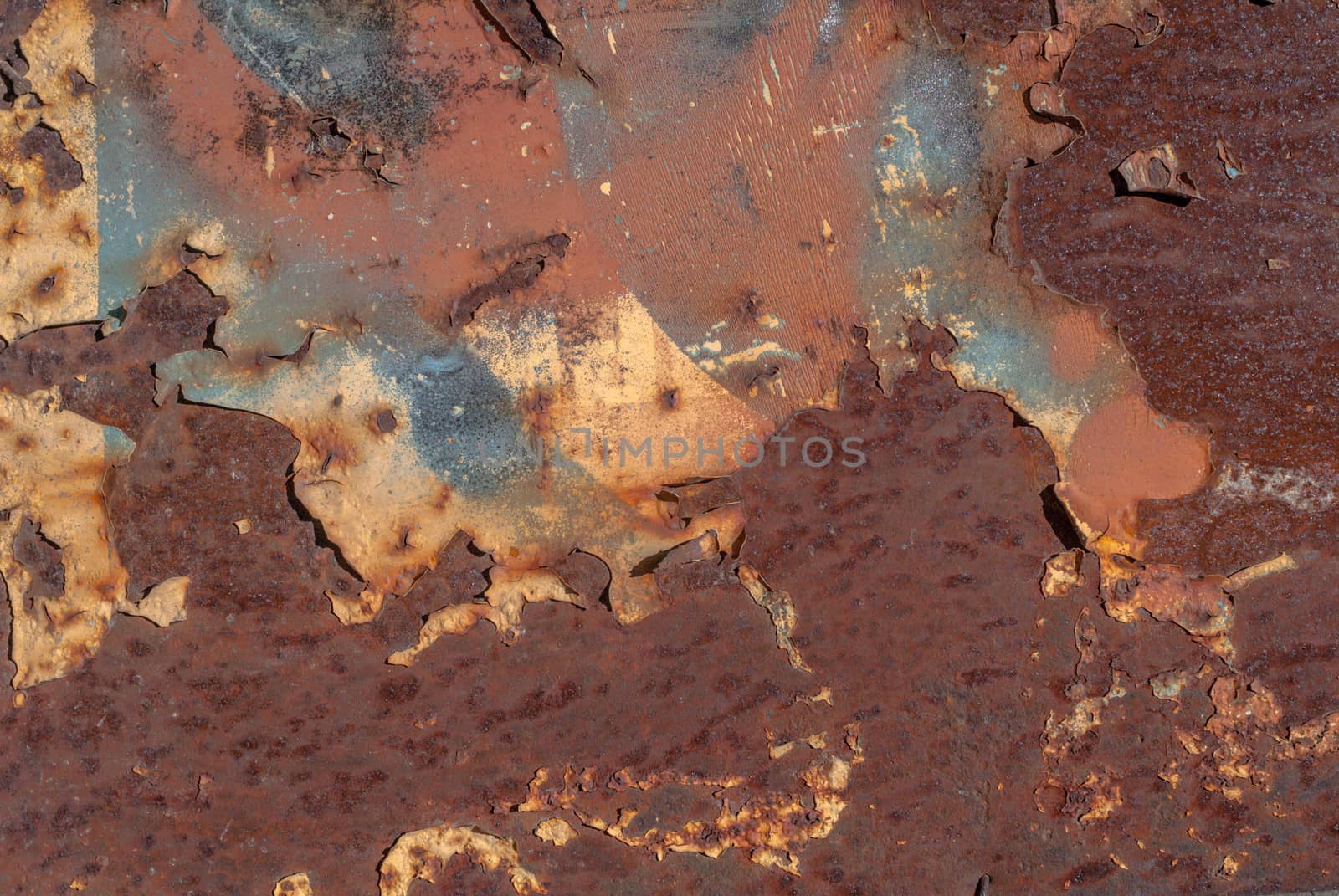 rusty iron surface covered with old chipped paint, which has long been influenced by different climatic conditions