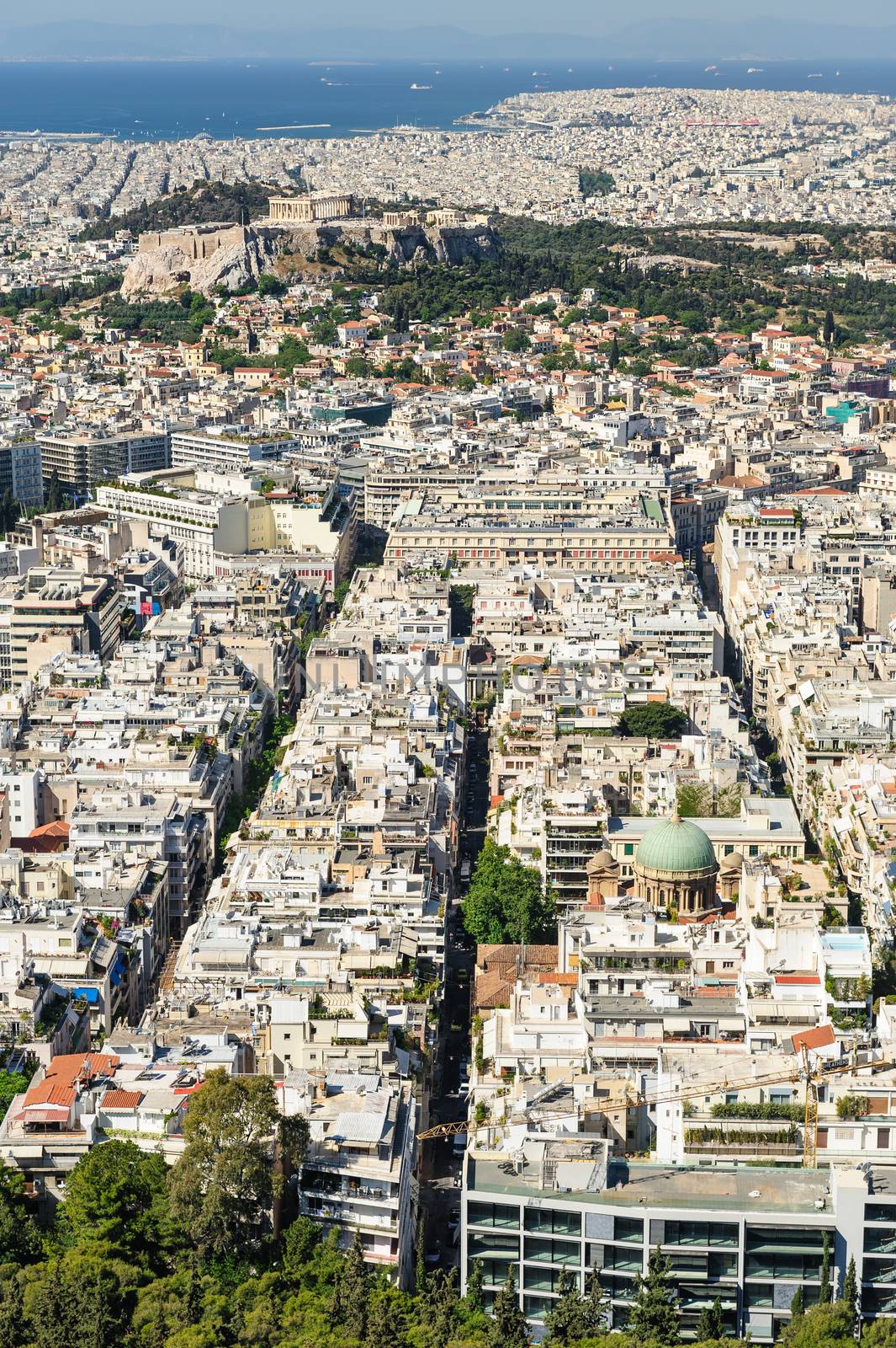 Cityscape of Athens, Greece made at morning from Lycabettus Hill. Acropolis hill can be seen.