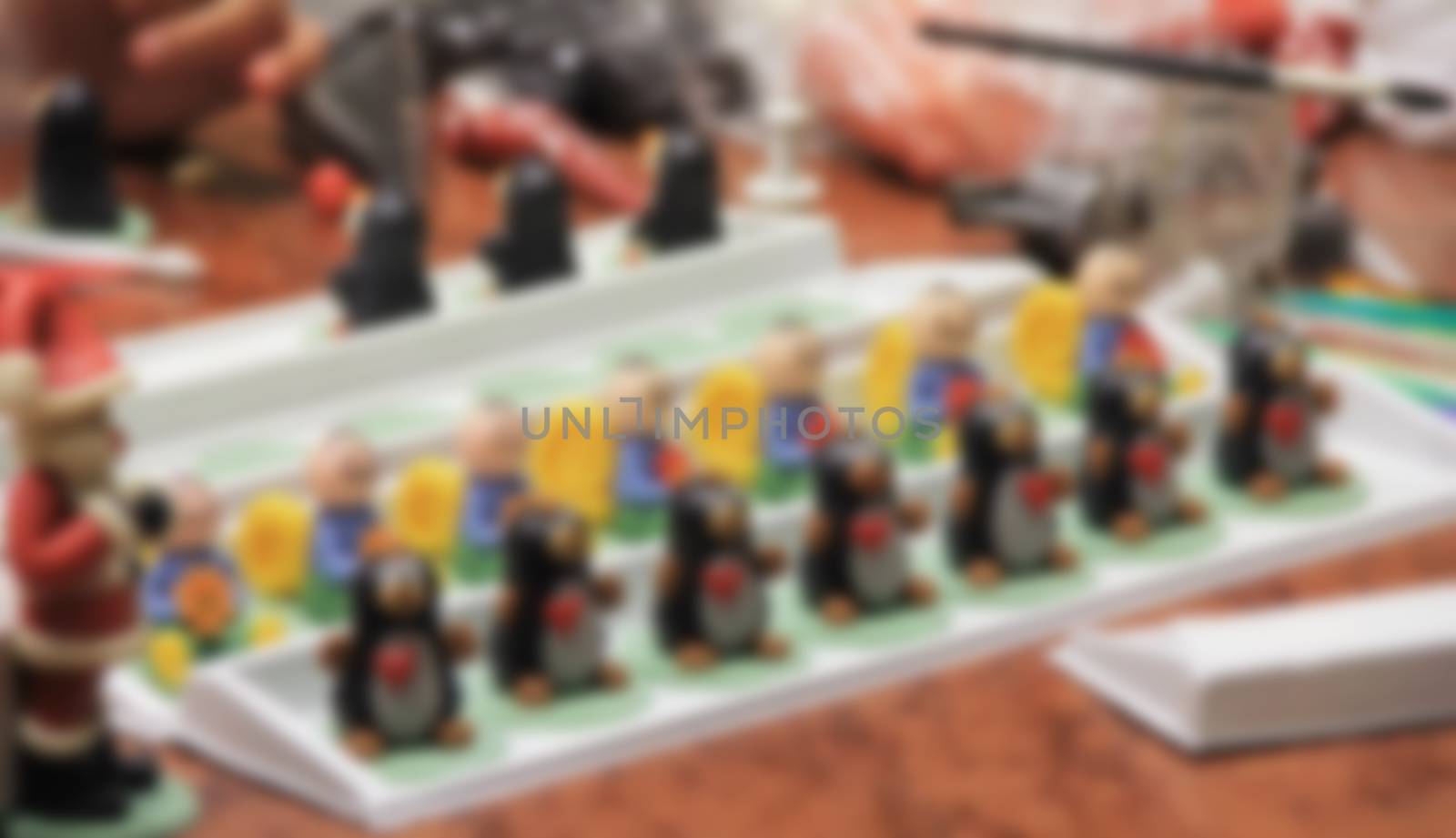 figures of marzipan modeling, preparation of sweet decorations for cakes and pies, women's hands, marzipan museum,  blurred