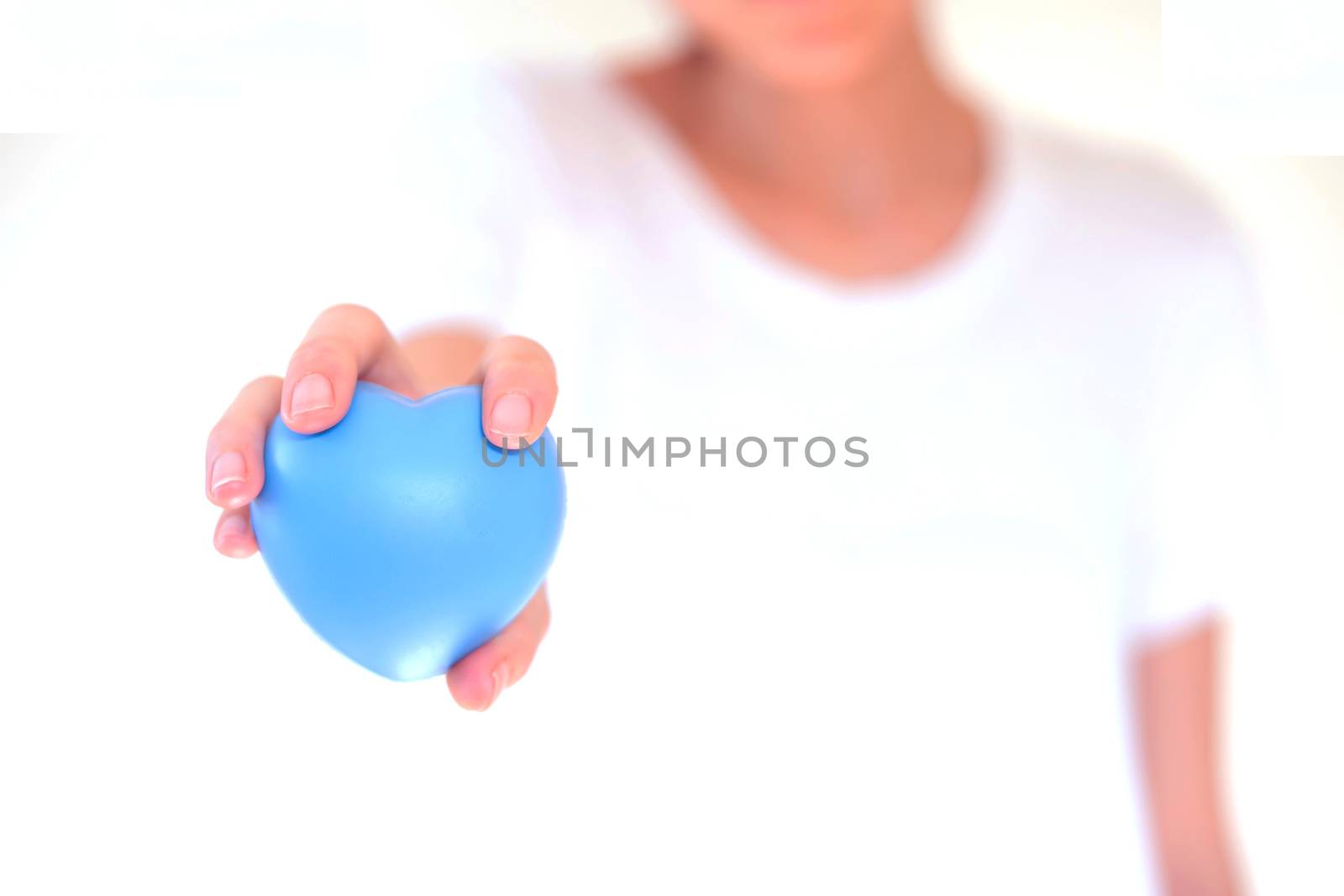 people, relationship and love concept - close up of womans cupped hands showing red heart