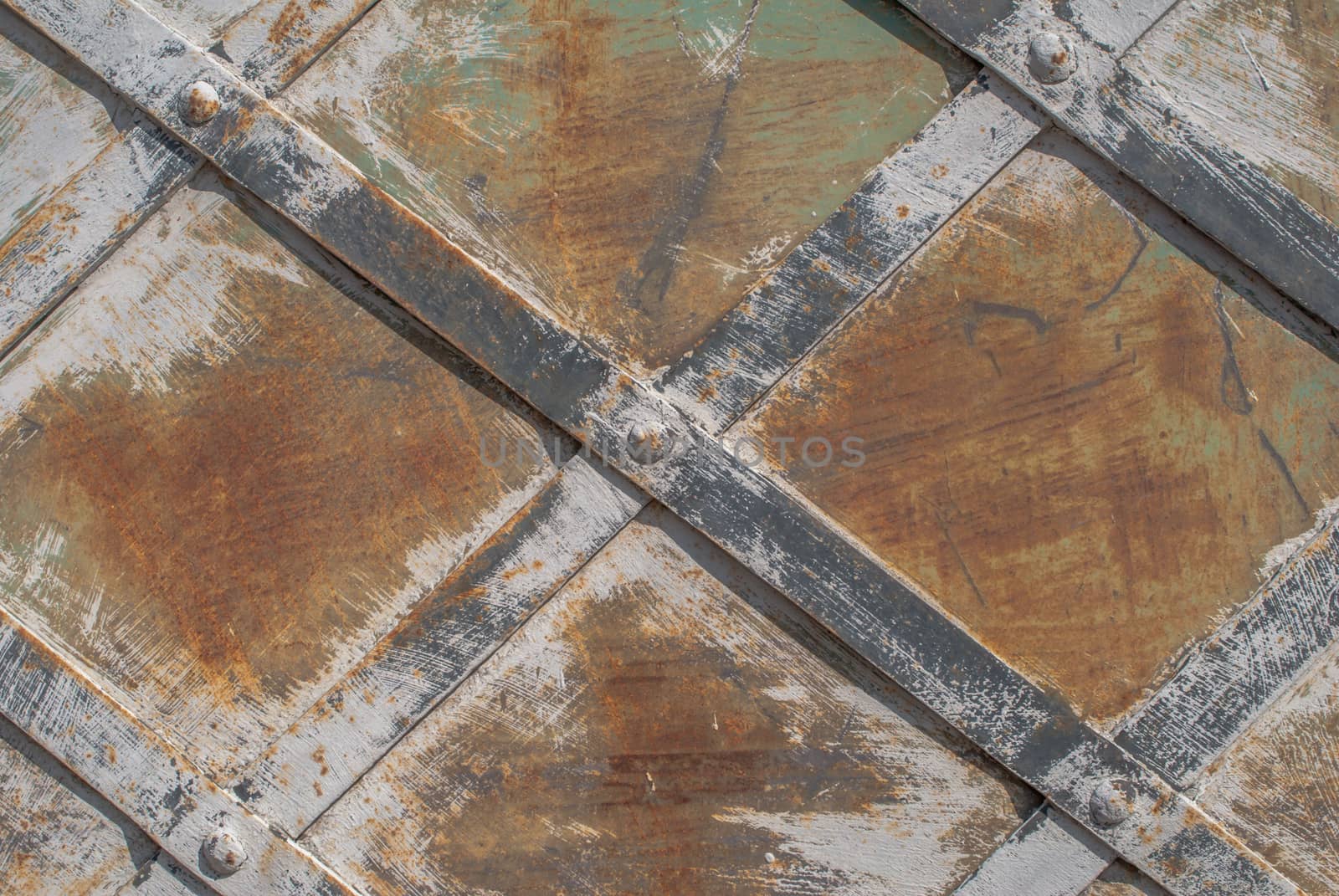 rusty iron surface covered with old chipped paint, which has long been influenced by different climatic conditions