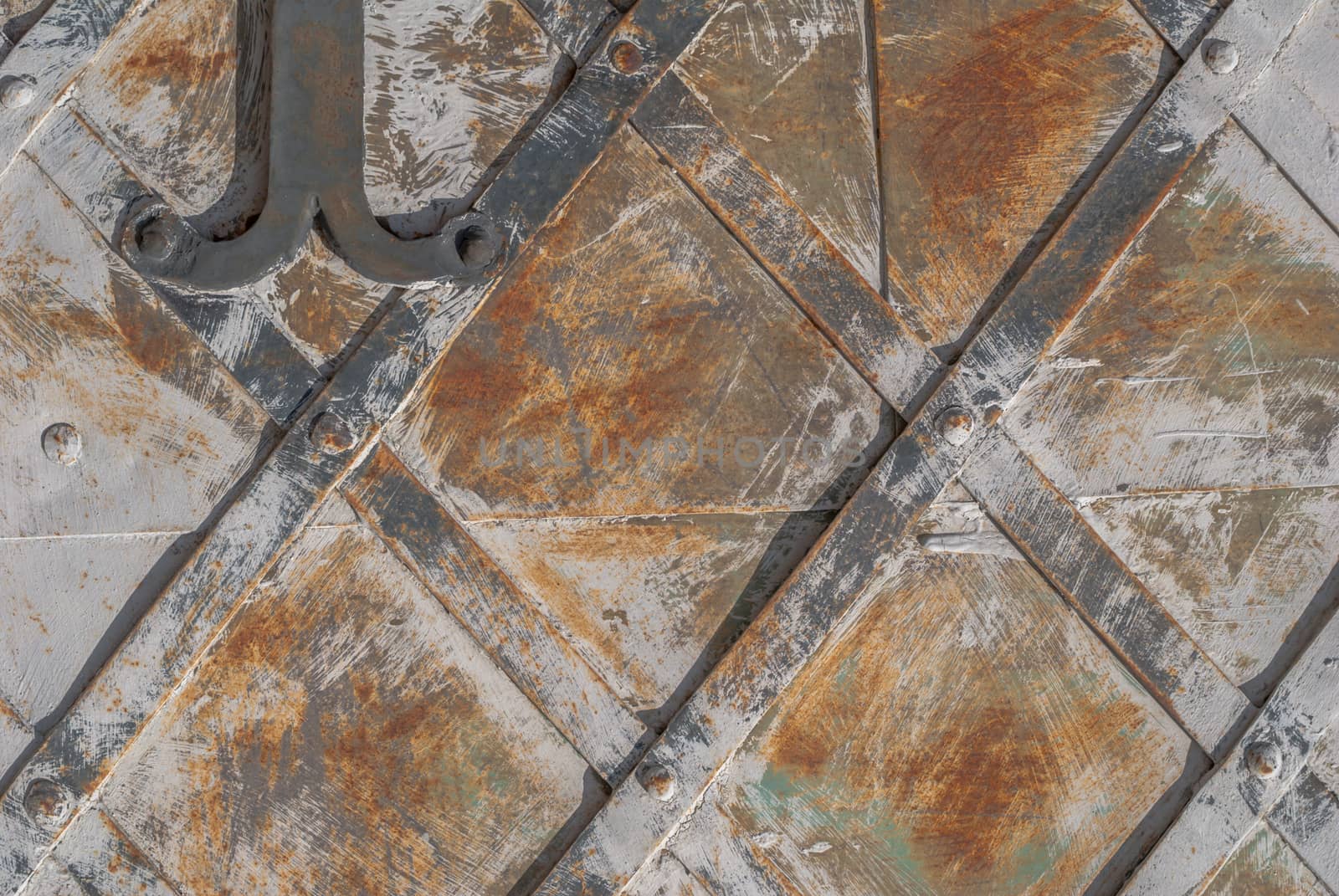 rusty iron surface covered with old chipped paint, which has long been influenced by different climatic conditions