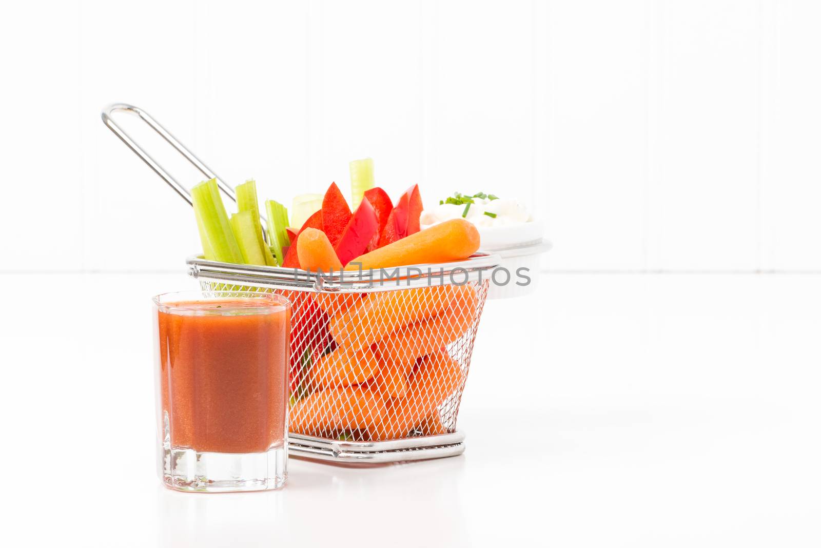 Raw vegetables in a fryer basket suggesting an alternative to fast food.