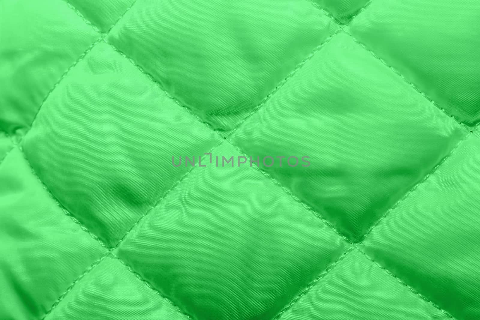 quilted fabric texture of green  color for hammering, backgrounds and textures
