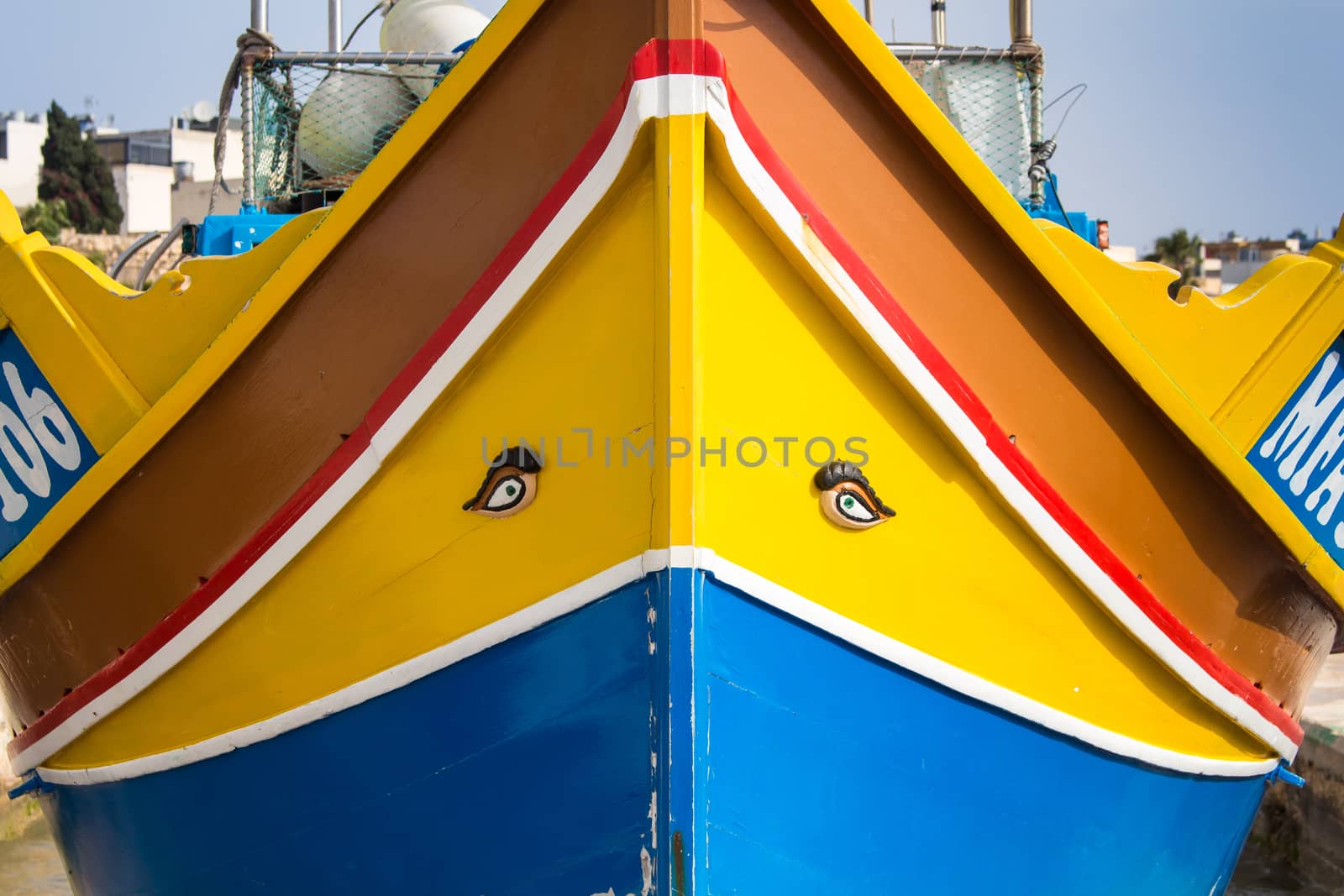 Traditional colorful fishing boat. Painted eyes for a good luck. Fishing village Marsaxlokk at the island Malta in mediterranean sea.